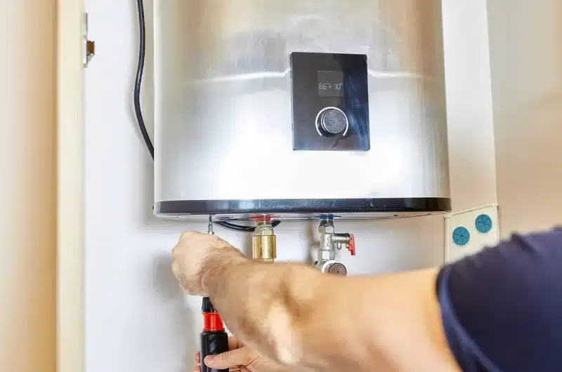 A Clear Choice technician installing a new water heater in an Englewood home