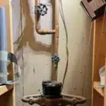 Plumber installing new PEX supply lines in an opened wall-whole-home repipe